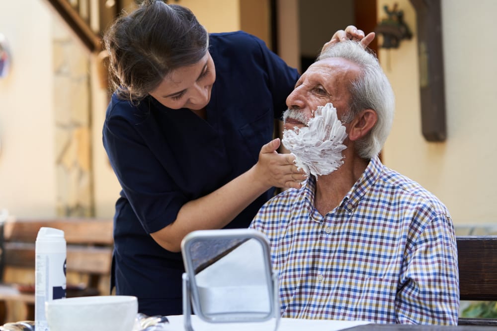 Caregiver and a senior man during home visit